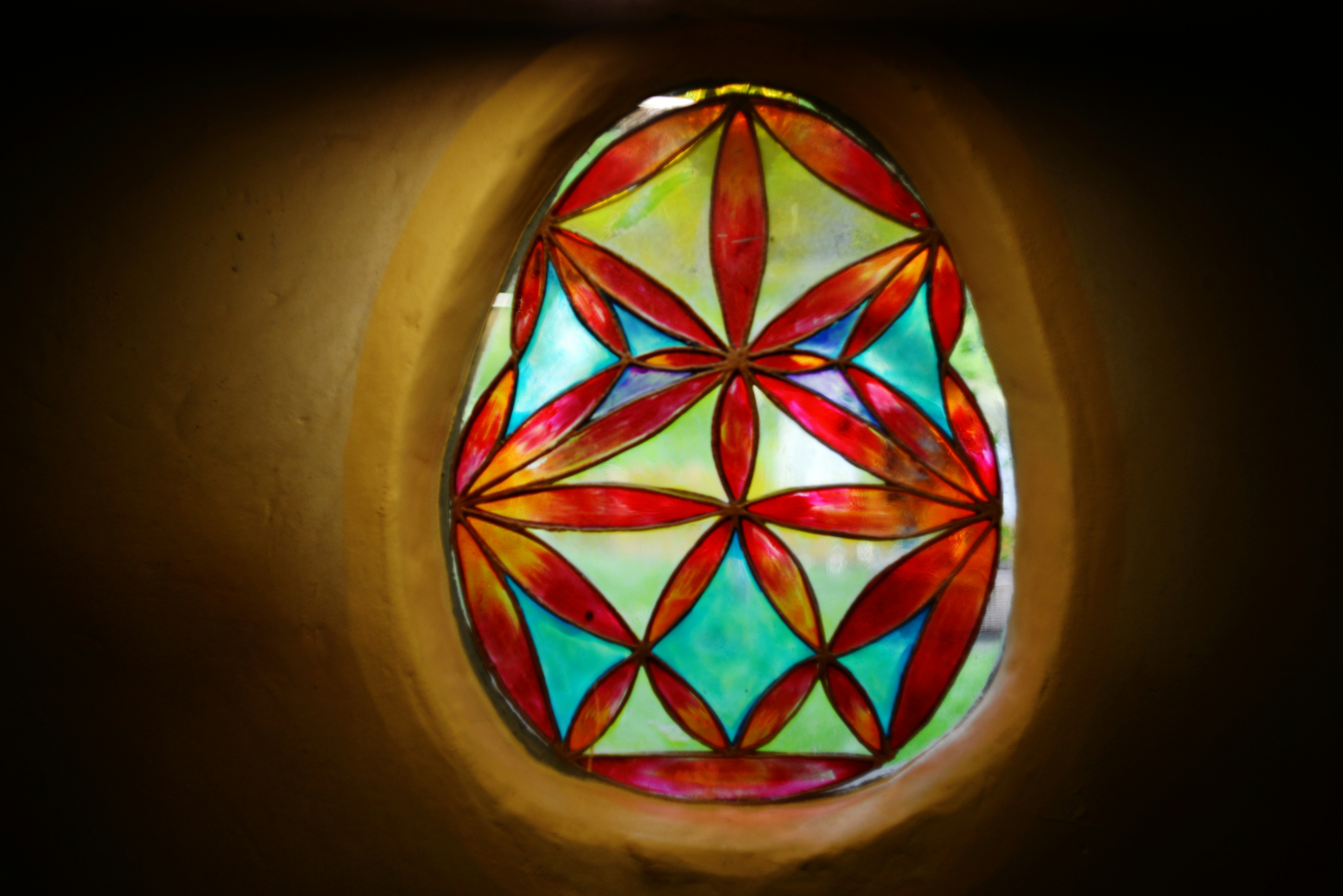 Stained glass window with geometric floral design.