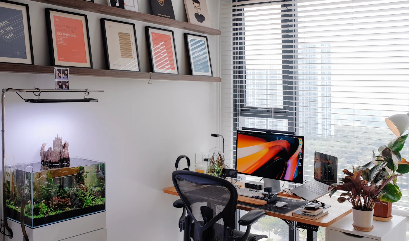 Planted freshwater aquarium on a cabinet in a modern workspace