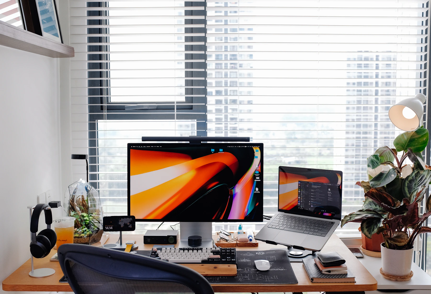 A calm, organized home workspace with a desk, chair, and natural light