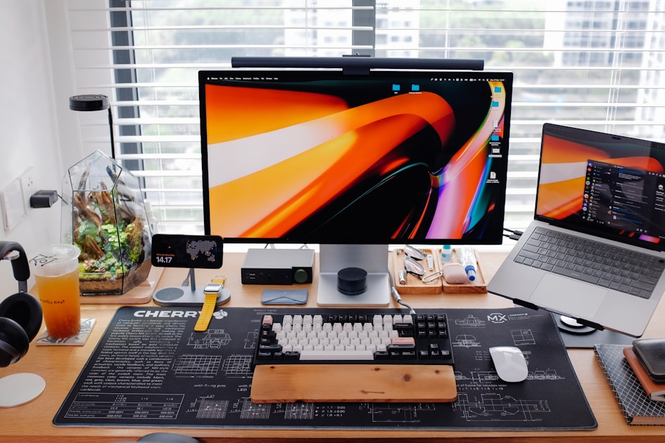 A modern research desk with multiple screens open showing browser tabs and data, representing cross-platform customer research