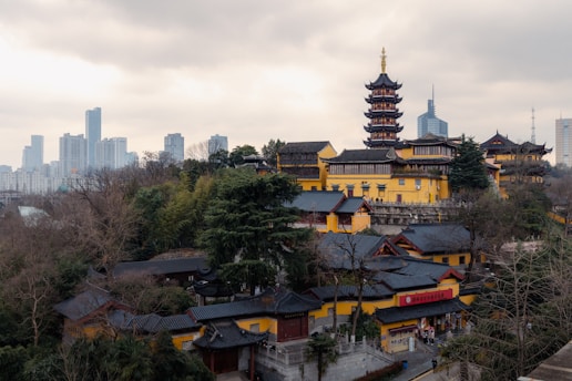 A traditional temple is seen with city skyscrapers.