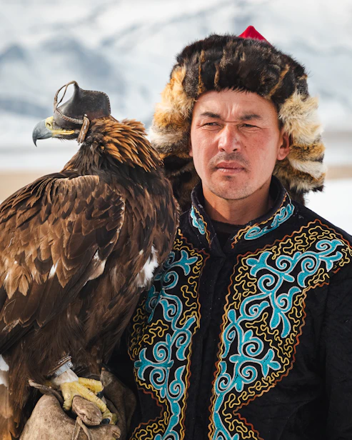 A man poses with his trained eagle.