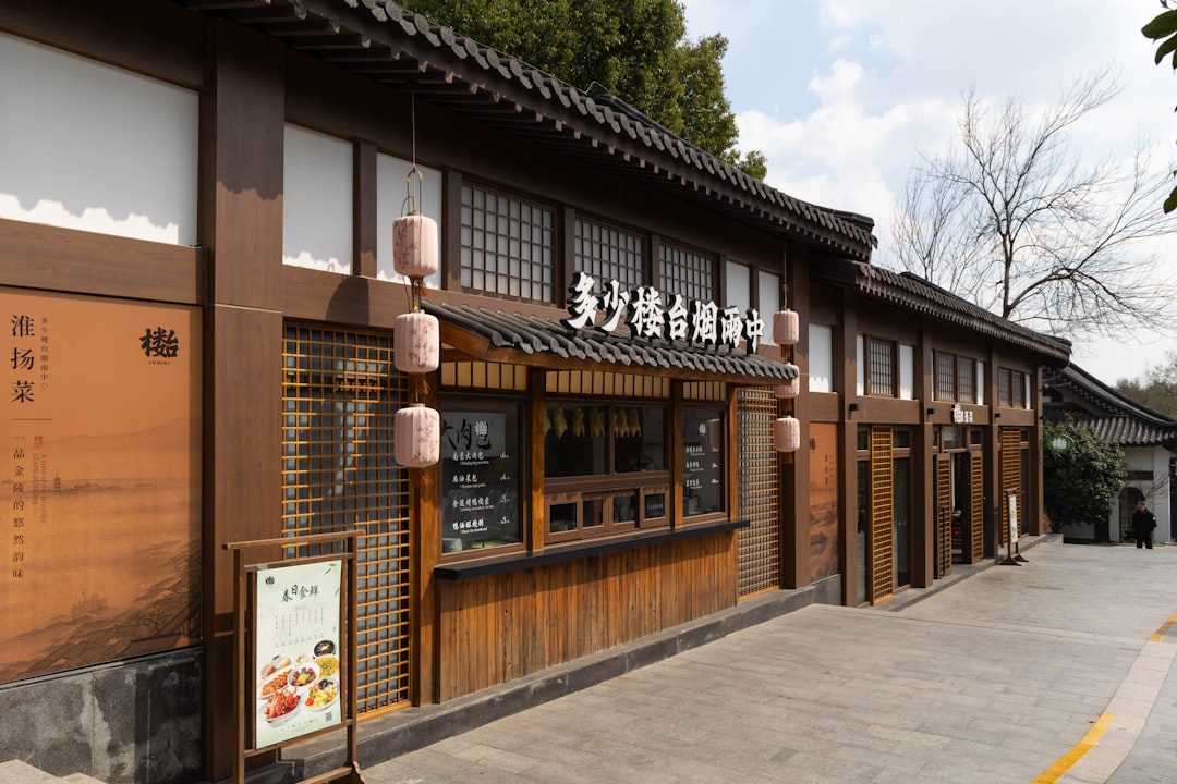 Traditional chinese building with lanterns in the daylight., Zhongshan Scenic Area Eatery: Traditional Charm of Huaiyang Cuisine