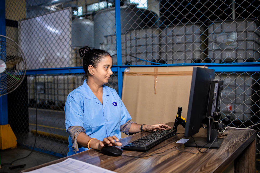 Warehouse team member using a computer to manage inventory and order data