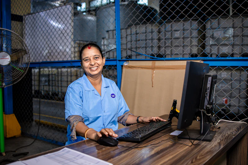 An operator working at a desk on a production floor