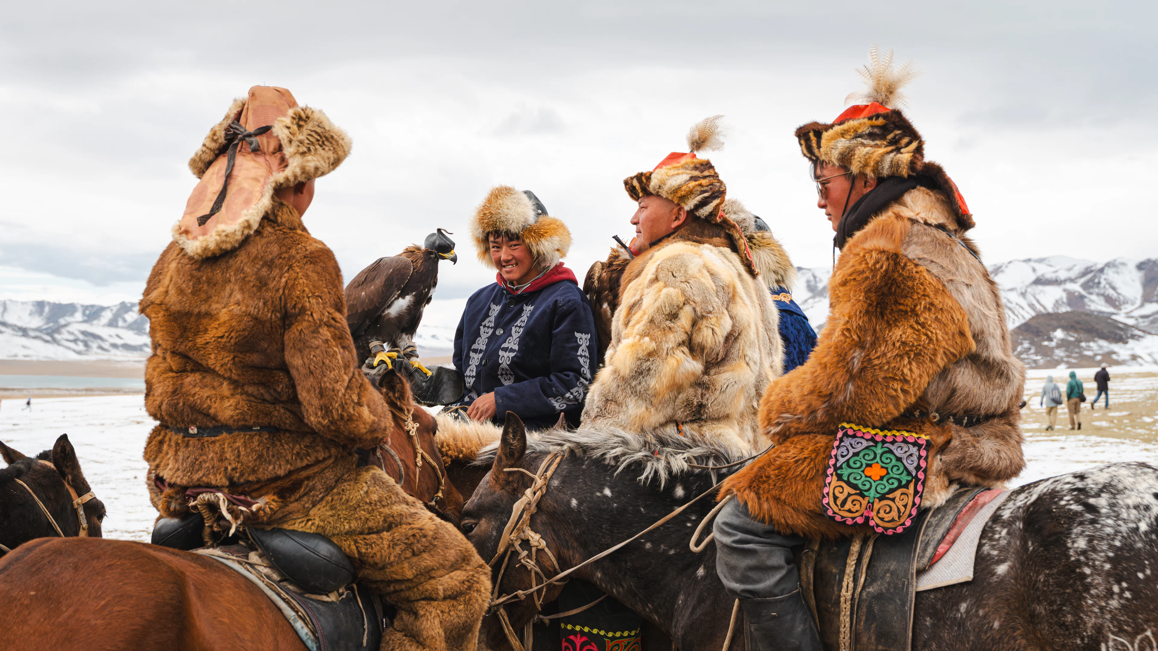 Eagle hunters in fur coats gathered on horseback