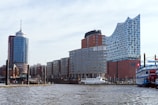 Modern buildings stand beside a waterway.