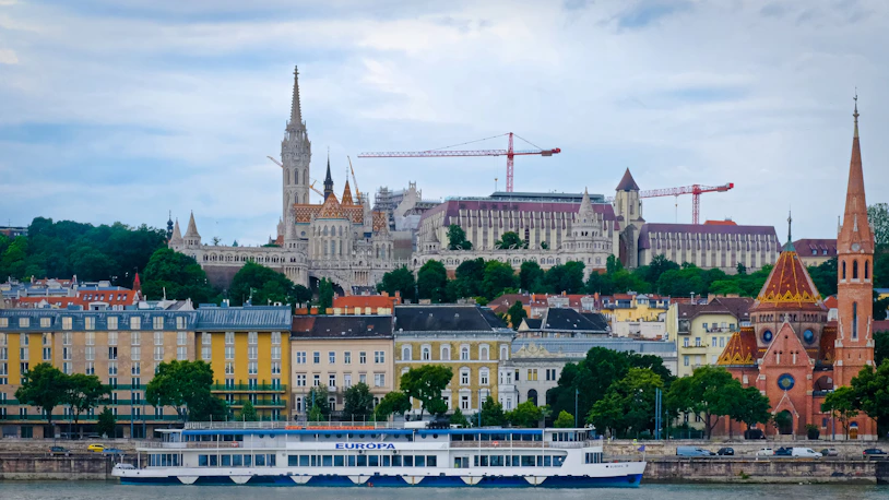 Beautiful budapest's cityscape with buildings and boats.