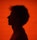 Silhouette of a man against a red background.