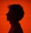 Silhouette of a man against a red background.