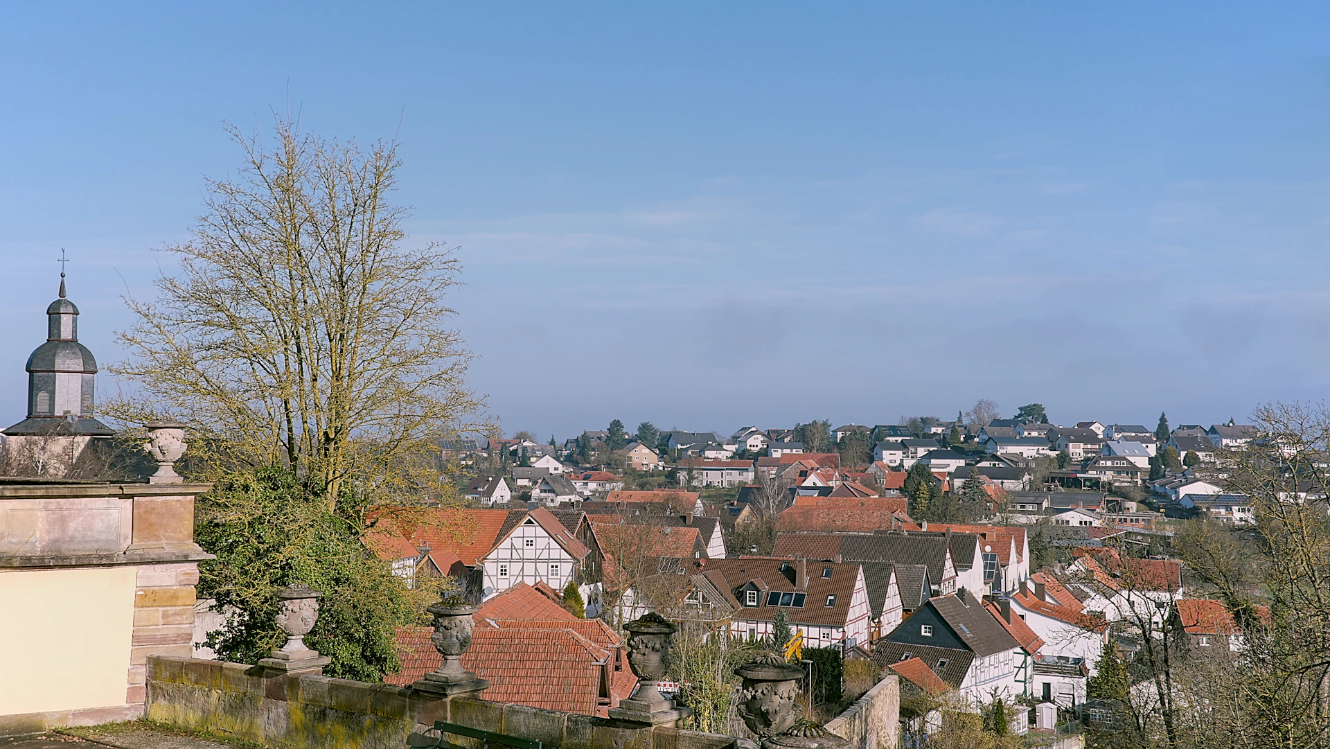 A quaint town nestled under a bright blue sky.