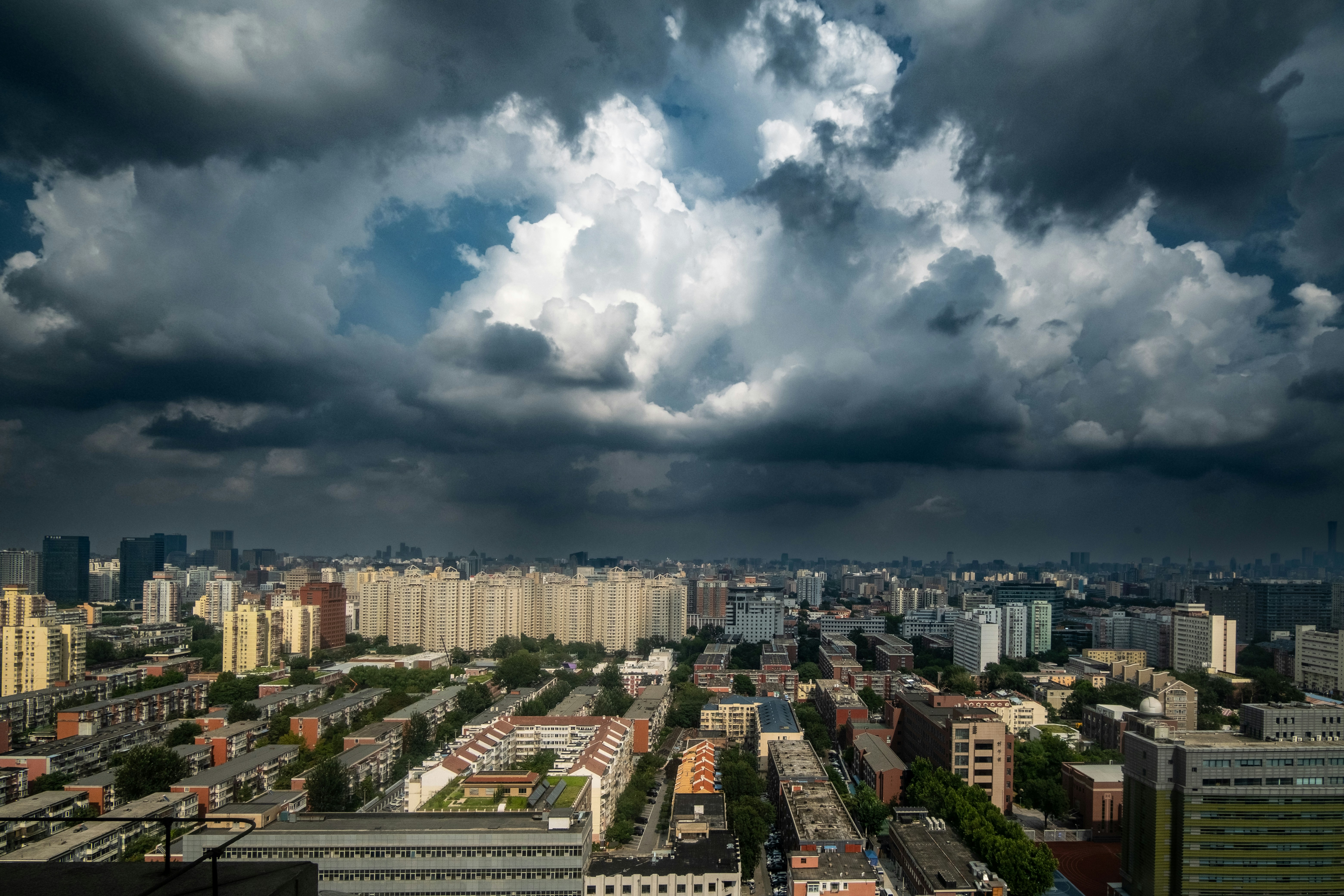 A stormy sky looms over a cityscape.