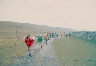 Hikers walk along a path in a rural area.