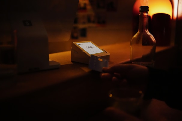 Someone is paying with a card at a bar.