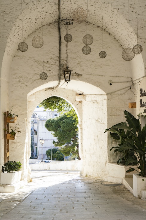 A white archway leads to the outdoors.