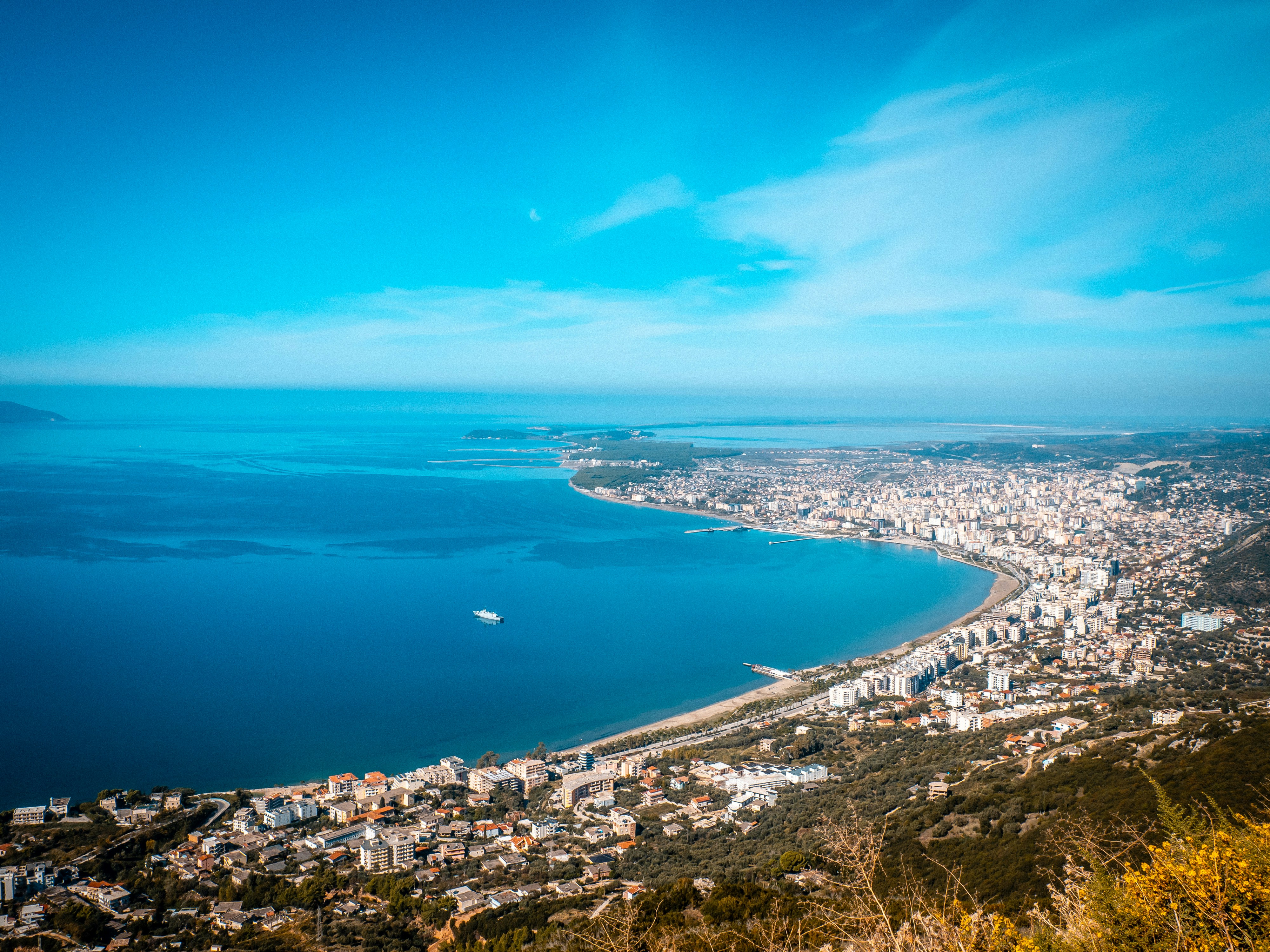 Coastal city with ocean and a clear blue sky.