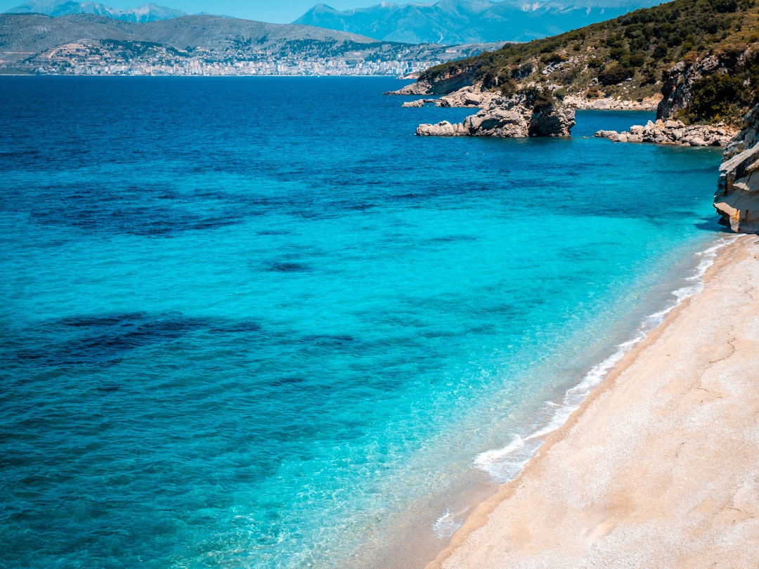 A beautiful beach with crystal clear blue water.,