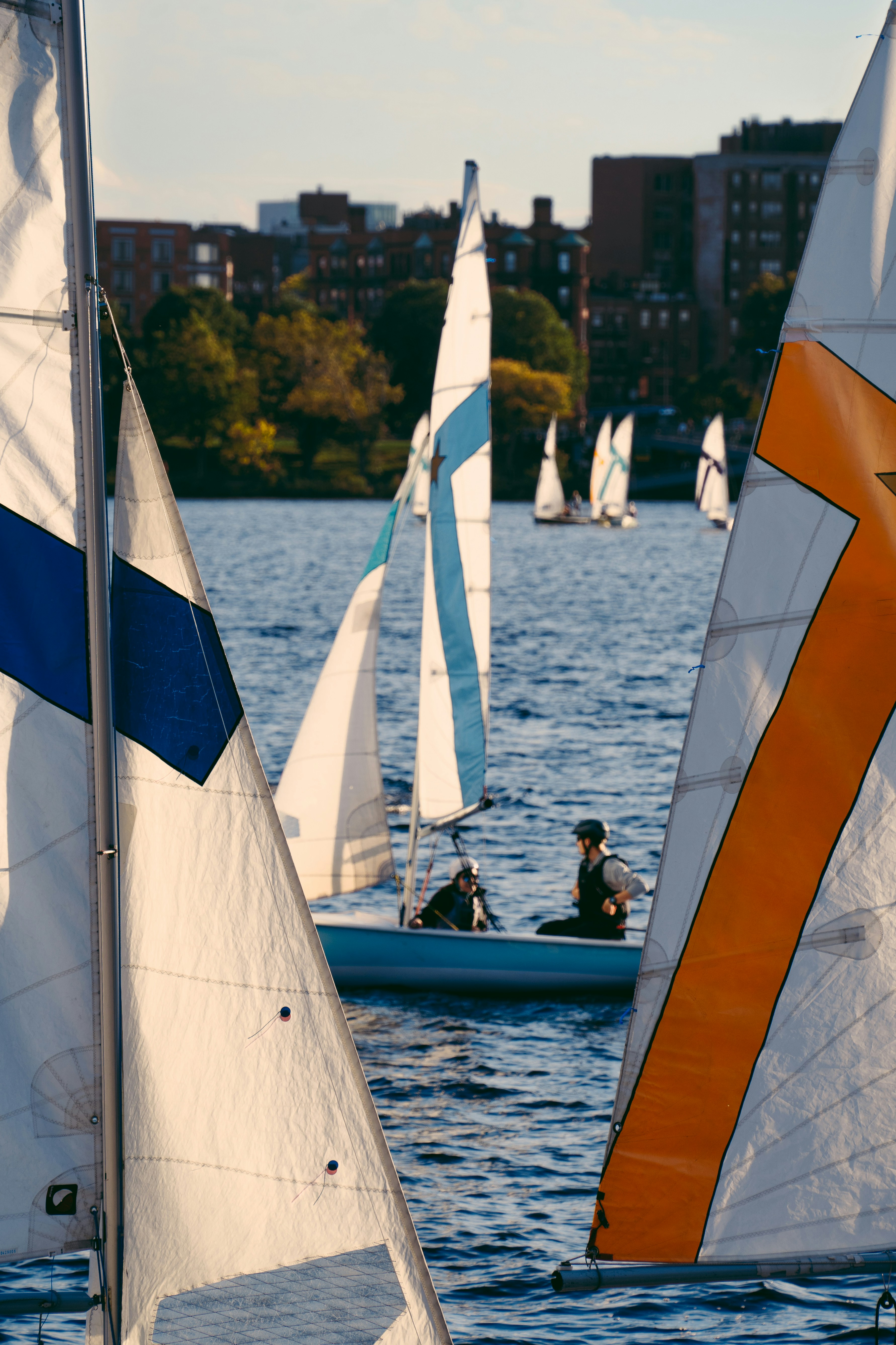 Sailboats are sailing on the water, enjoying the day.