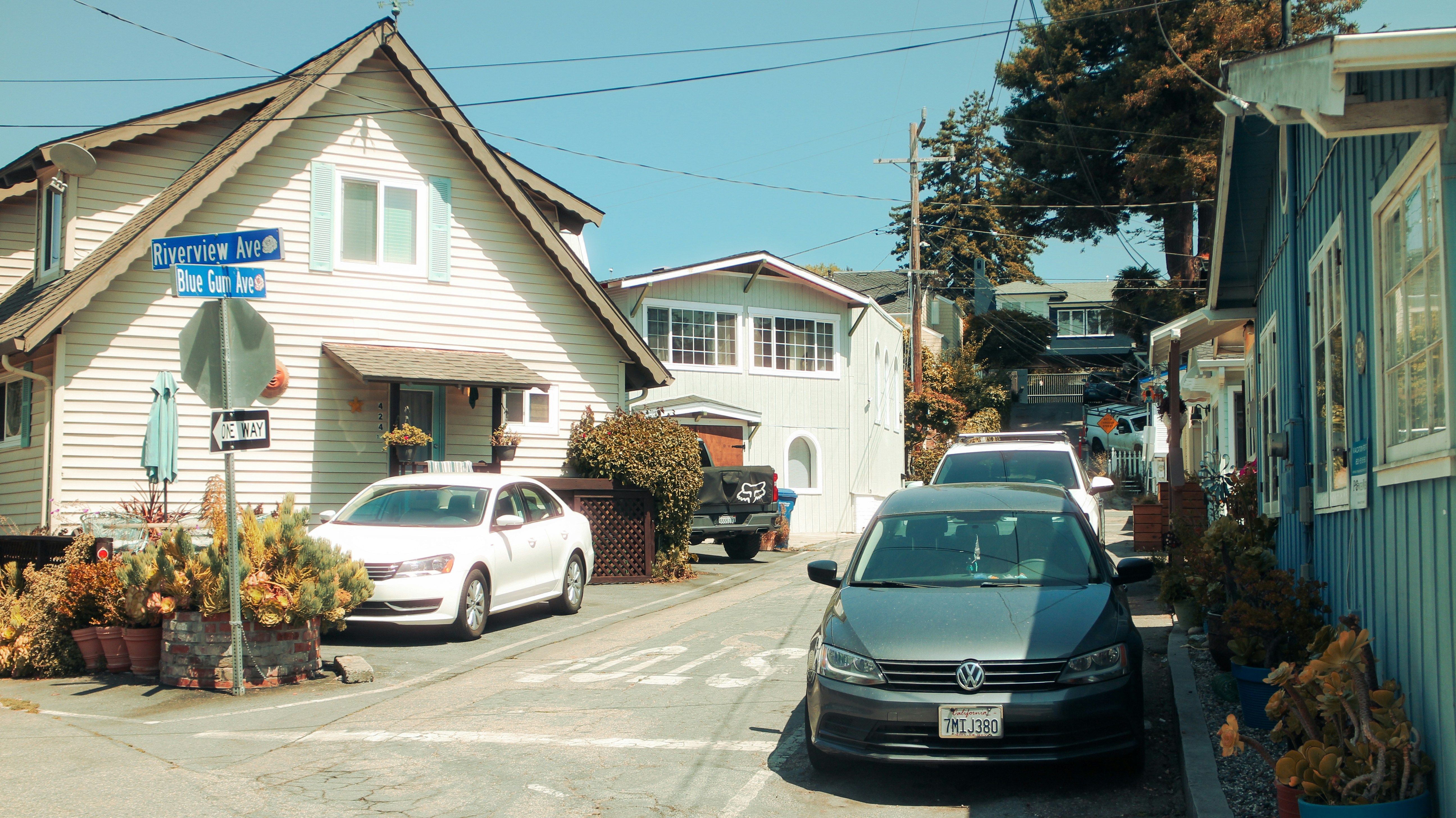 Family driving a modern electric SUV down a suburban street at sunset