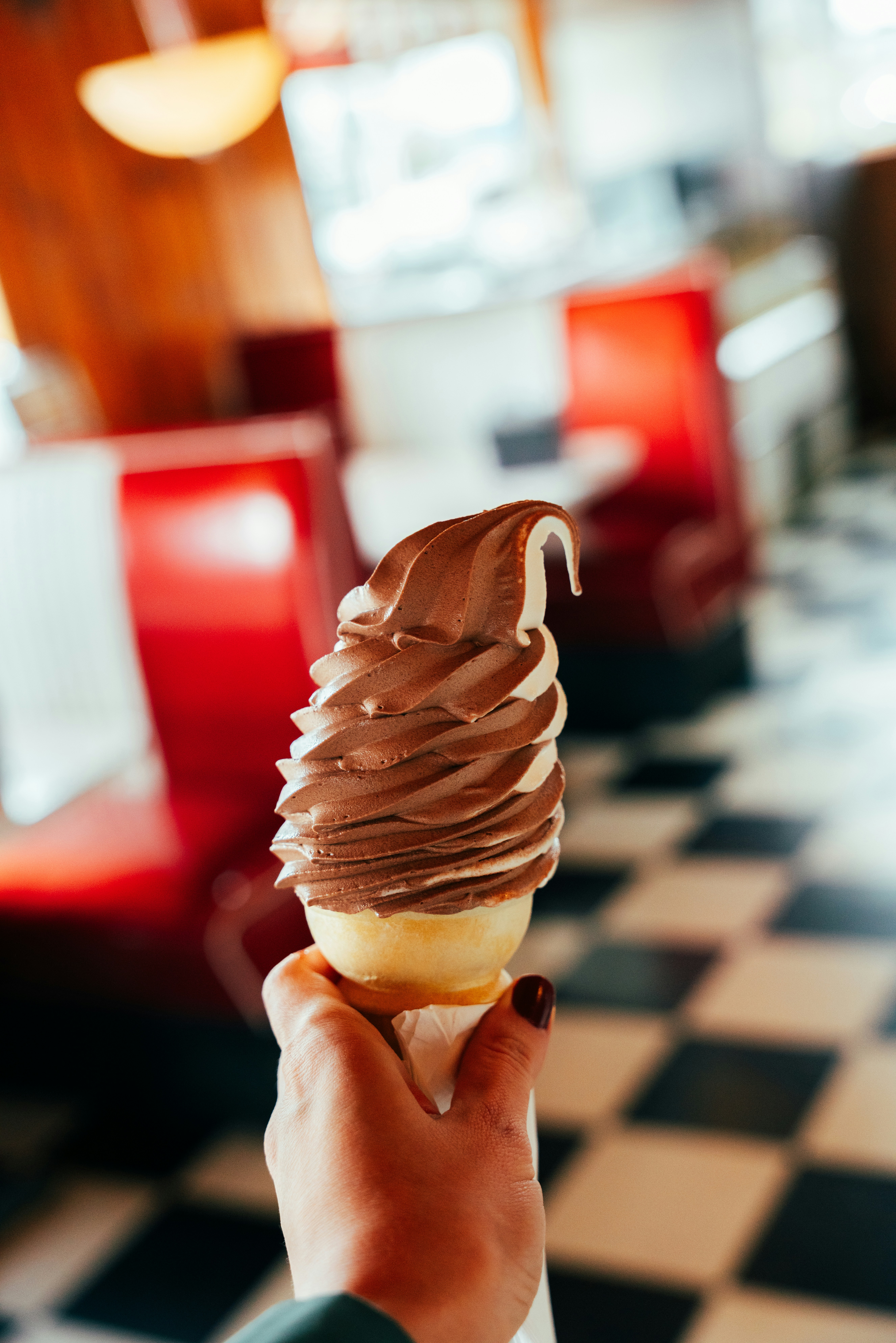 A hand holds a swirled ice