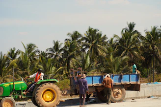 People are working with a tractor and trailer.