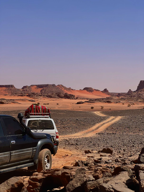 Deux 4x4 dans la Tadrart Rouge, près de Djanet. desert landscape