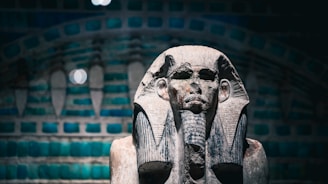 Ancient egyptian pharaoh statue with decorative background.