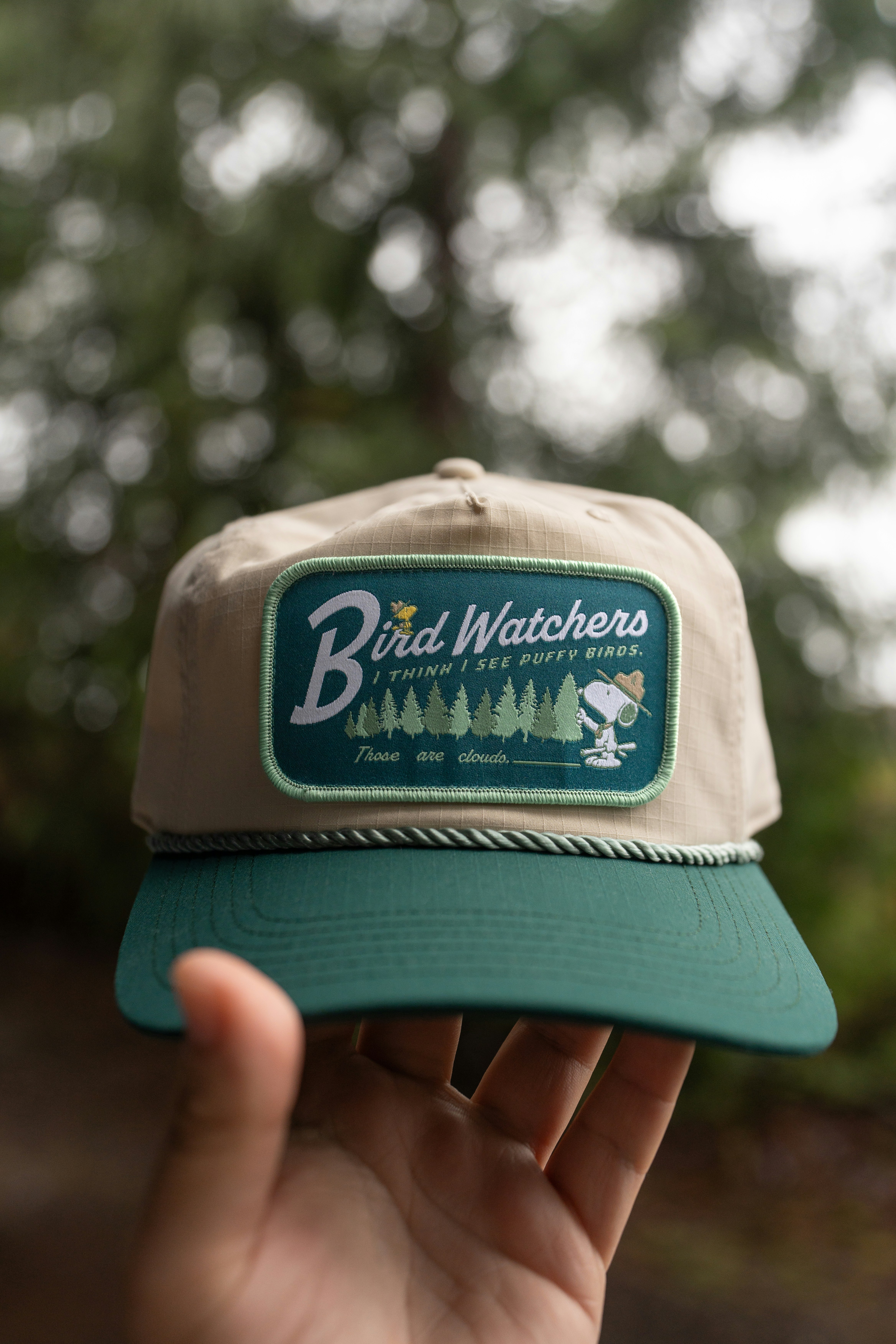 A "bird watchers" hat is being held.