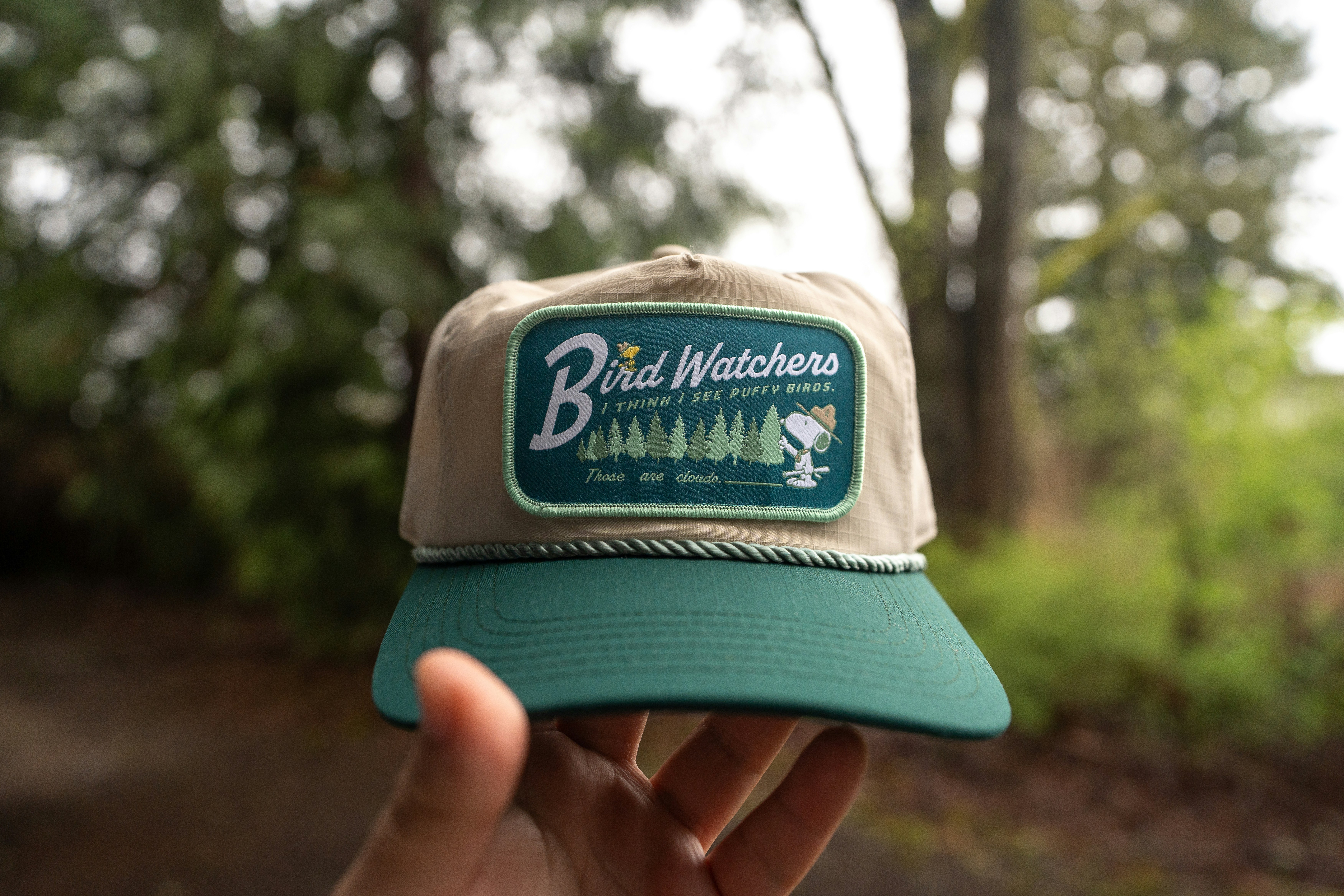 A "bird watchers" hat is being held.