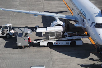 Ground crew loading luggage onto an airplane.