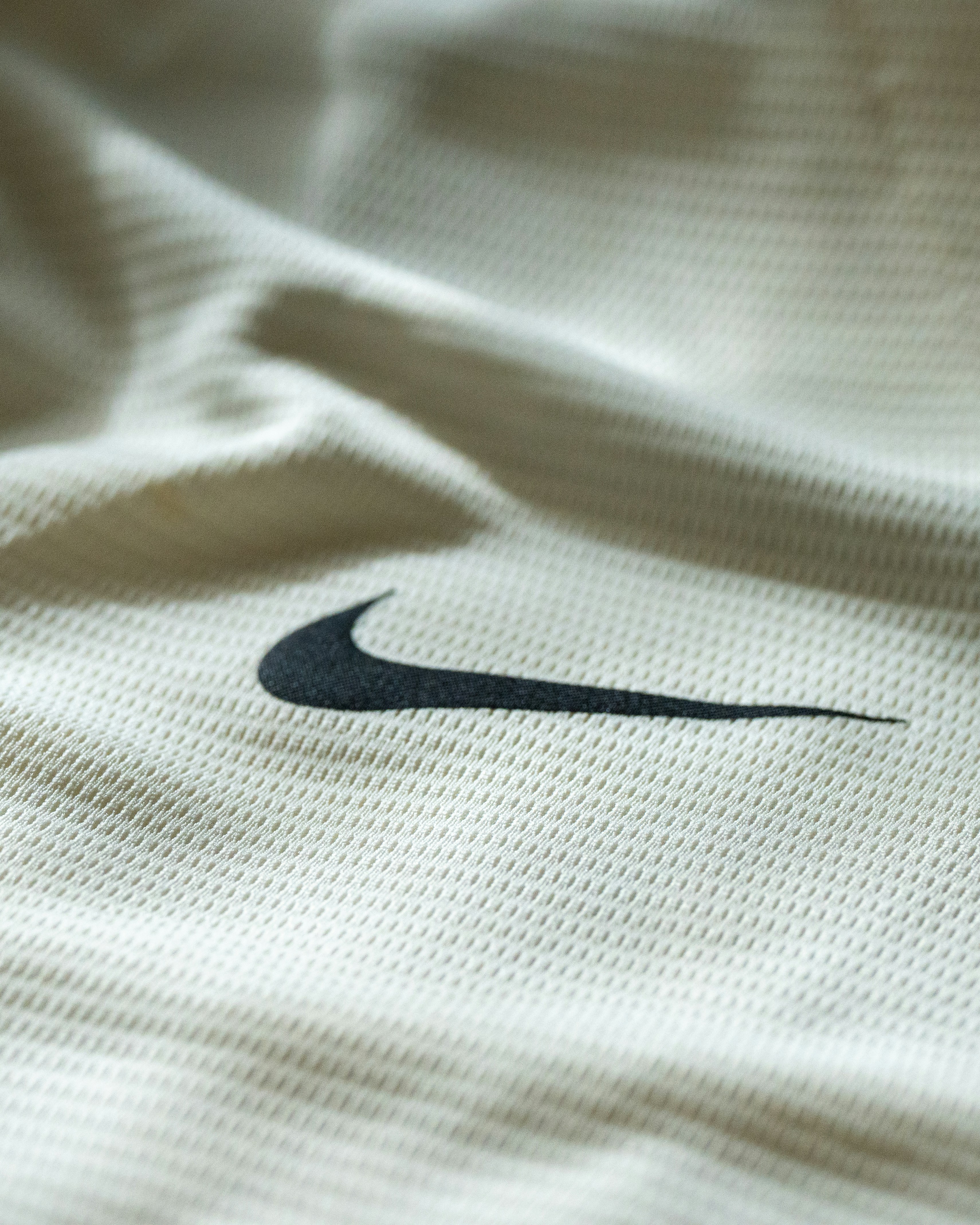 Nike's iconic swoosh logo is displayed on fabric.