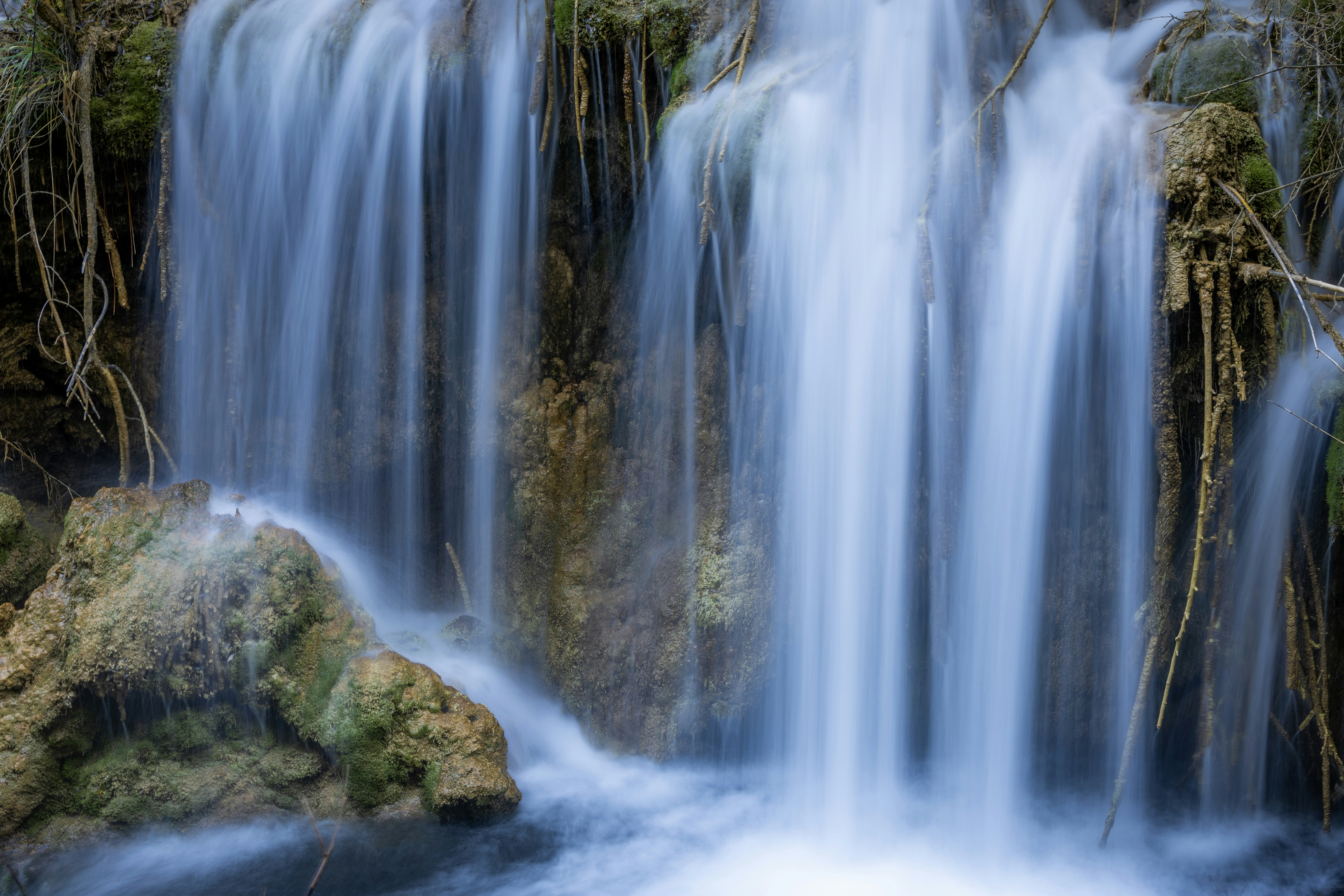 Water cascades down a small waterfall.