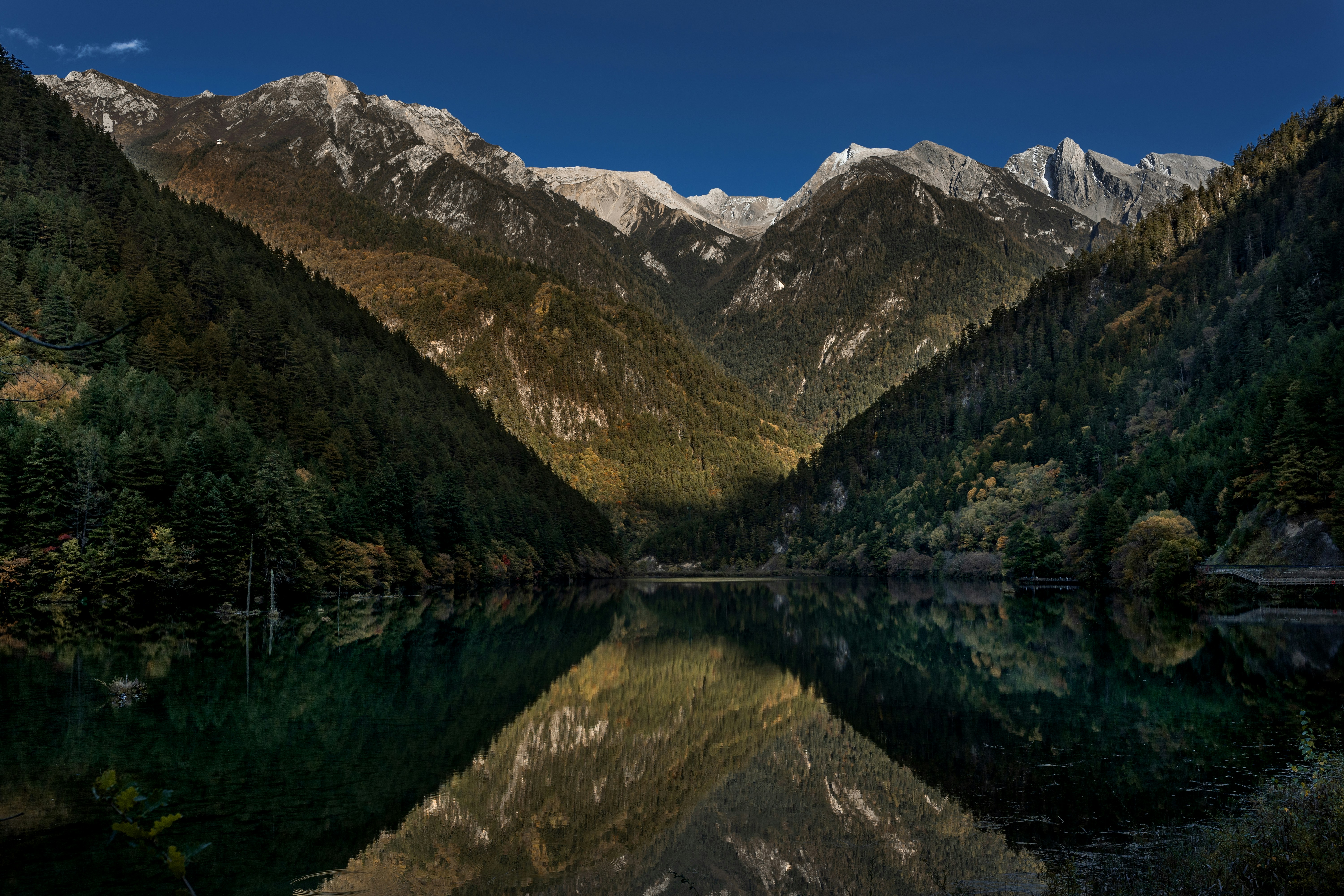 Mountains reflect in the still water.