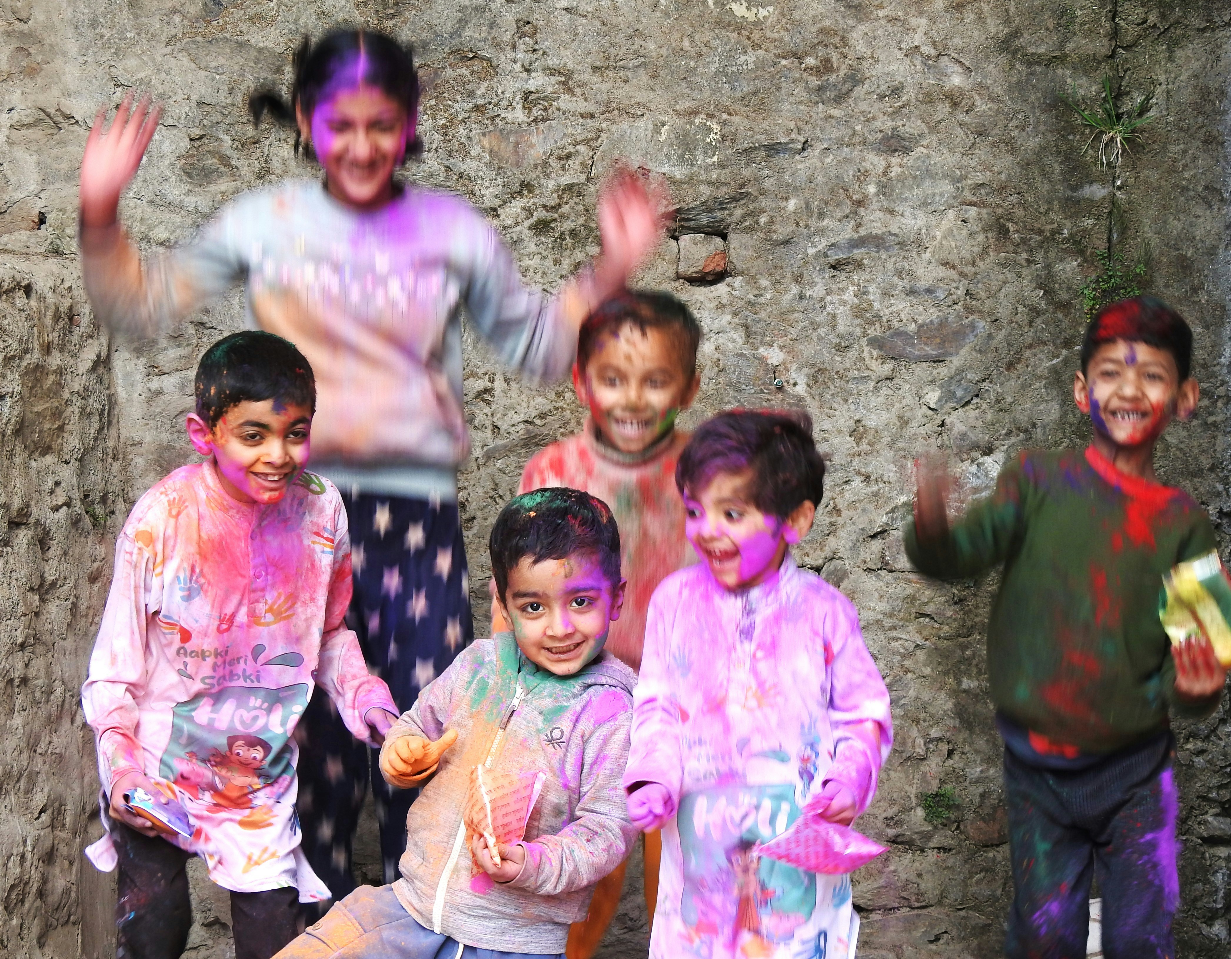 Kids celebrate holi with colorful powder and joy.