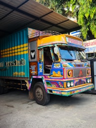 Brightly painted truck parked in a garage.