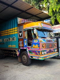 Brightly painted truck parked in a garage.