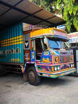 Brightly painted truck parked in a garage.
