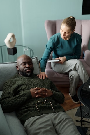 A therapist comforts their patient during a session.