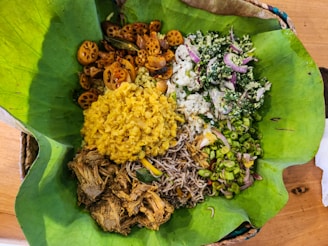 A sri lankan meal is presented on a leaf.