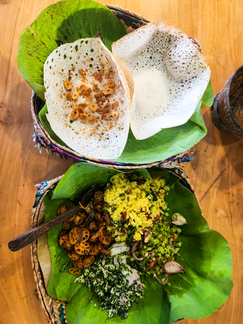 Sri Lankan egg hoppers and string hoppers with mallum and sambol