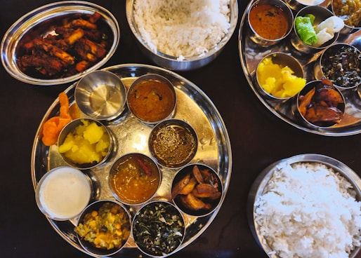 Indian thalis with rice and a variety of dishes.