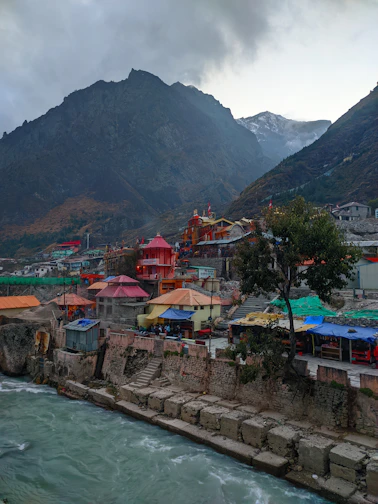 Colorful buildings nestled between mountains and water.