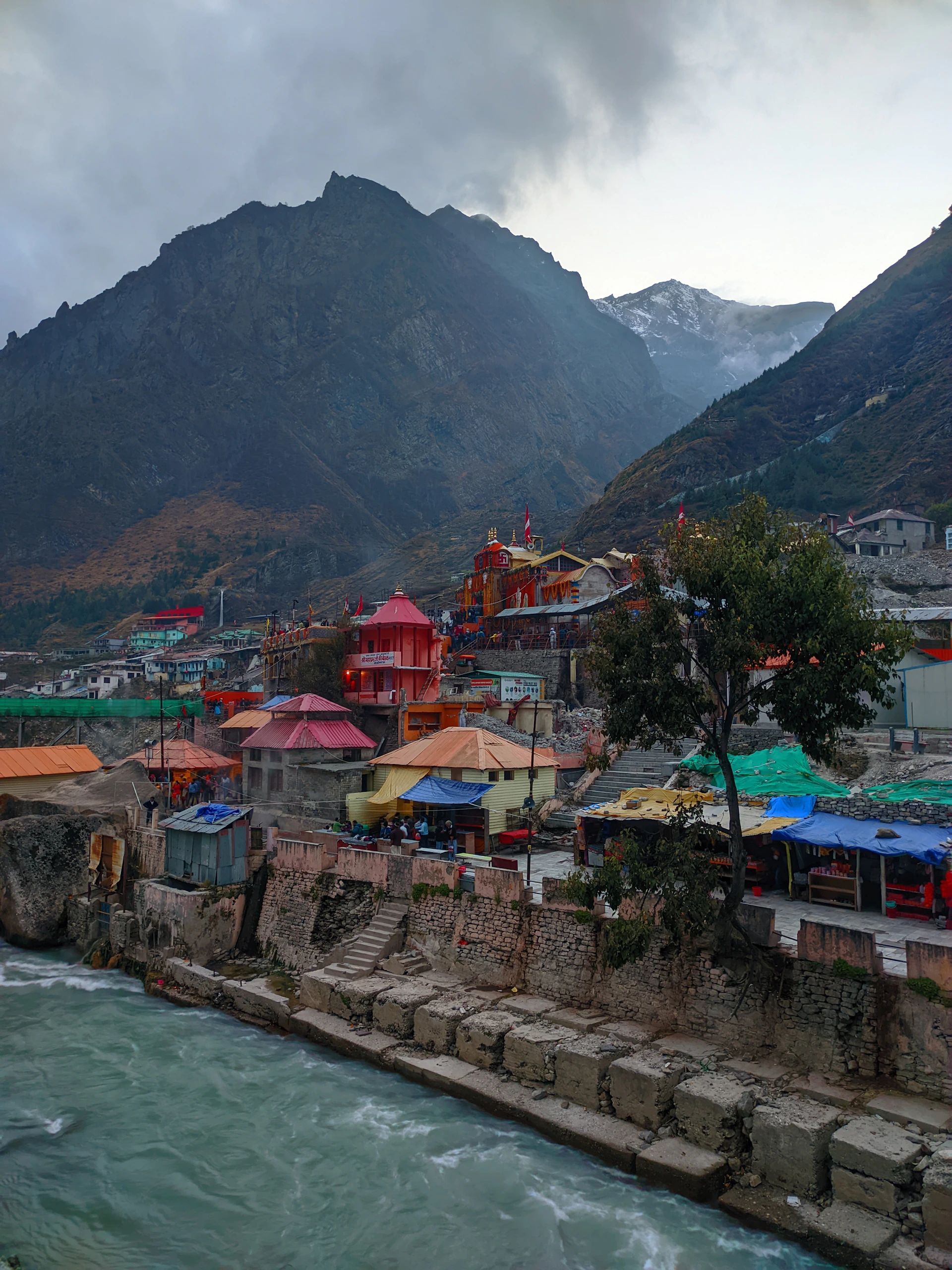 Colorful buildings nestled between mountains and water.
