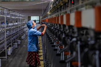 Woman working in a textile factory, operating machines.