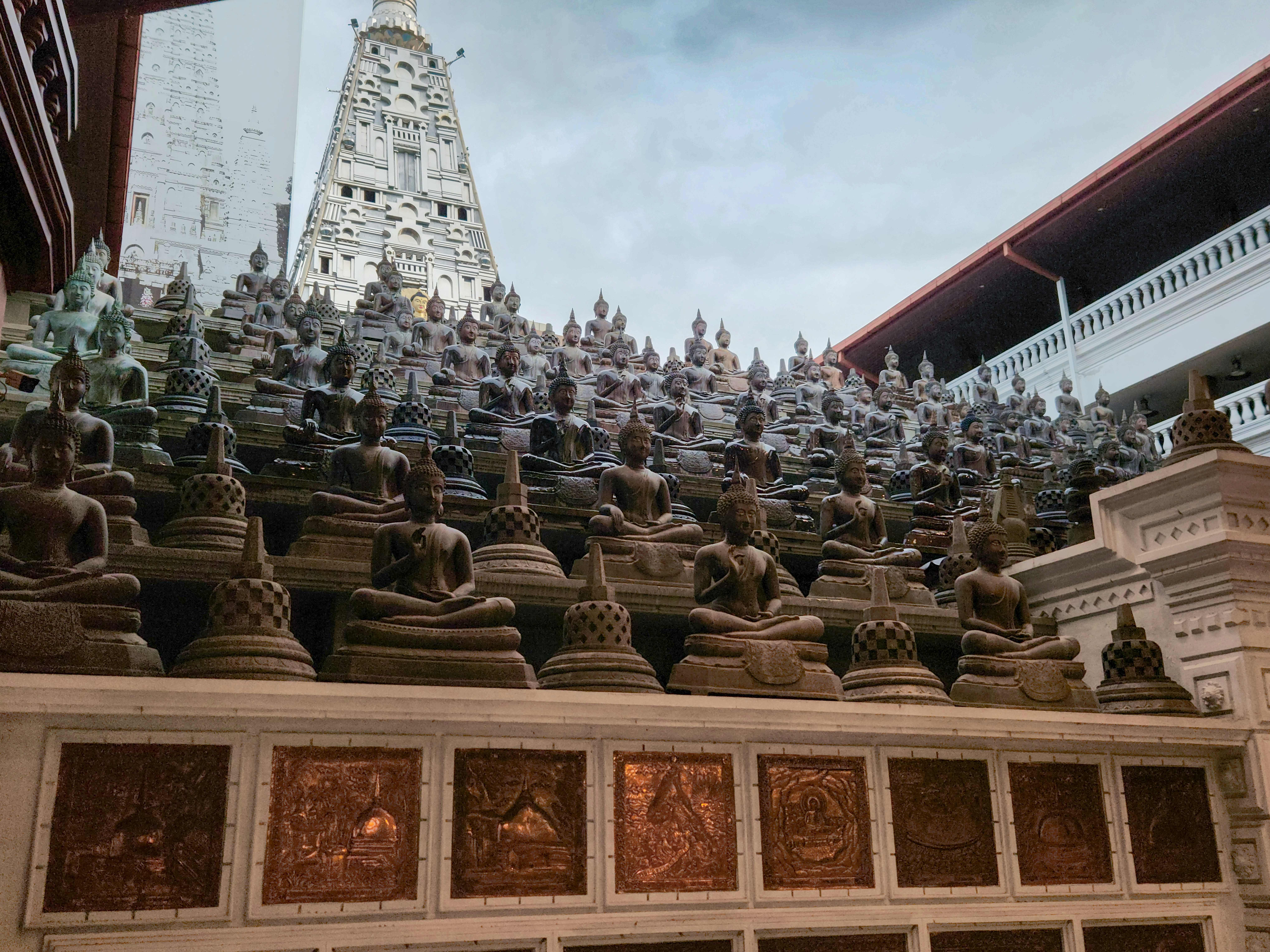 Many buddha statues are arranged for display.