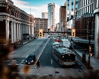 A busy city street with buildings and traffic.
