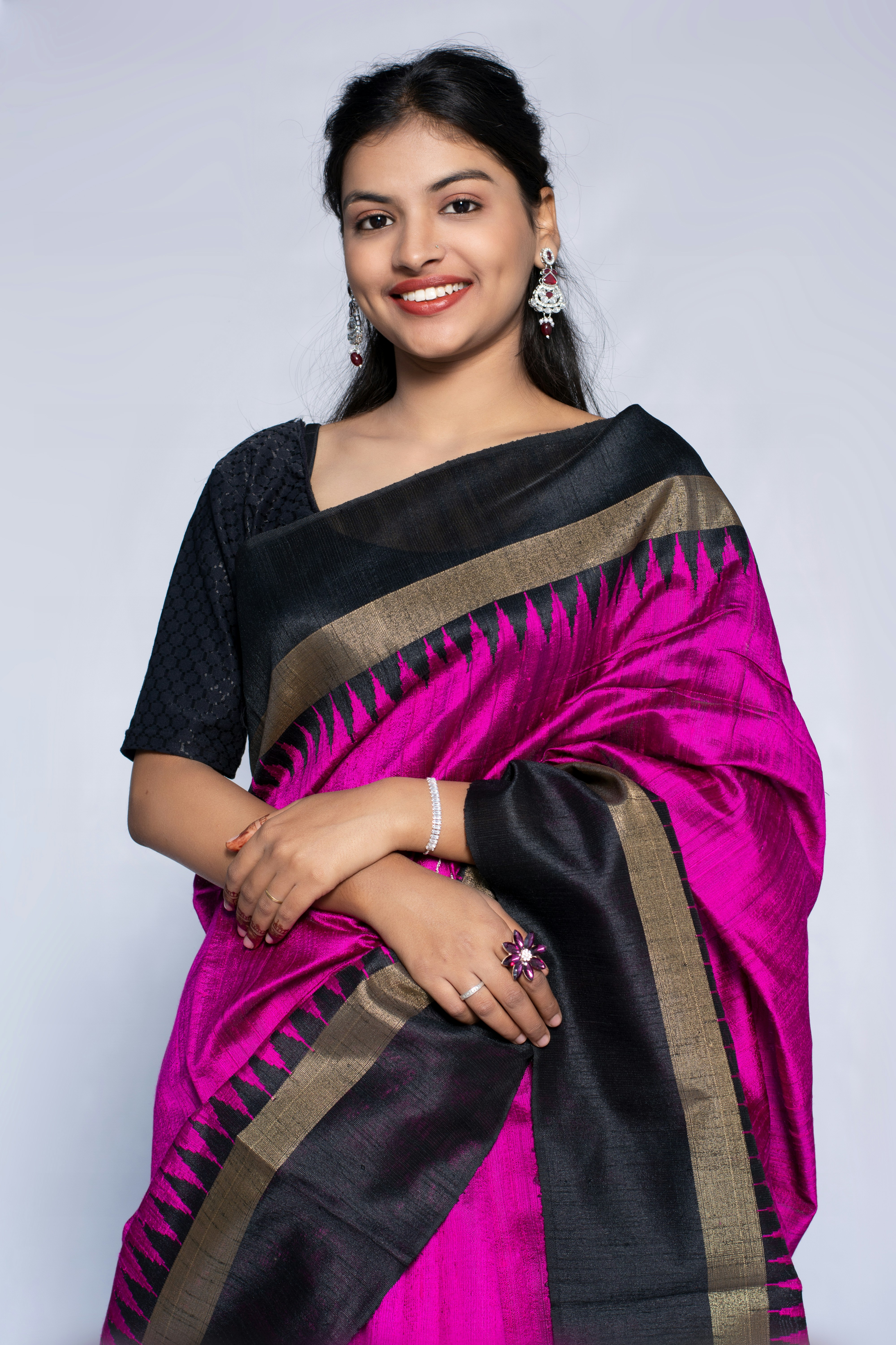 Beautiful woman in a pink and black saree.