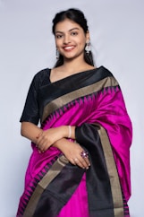 Beautiful woman in a pink and black saree.