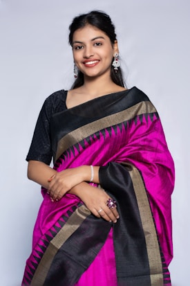 Beautiful woman in a pink and black saree.