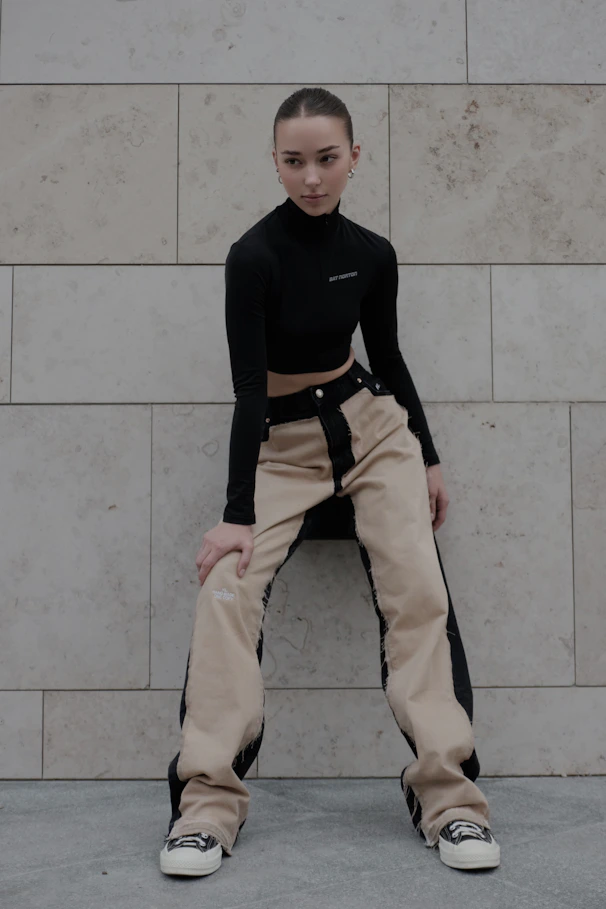 Woman posing in stylish, modern outfit.